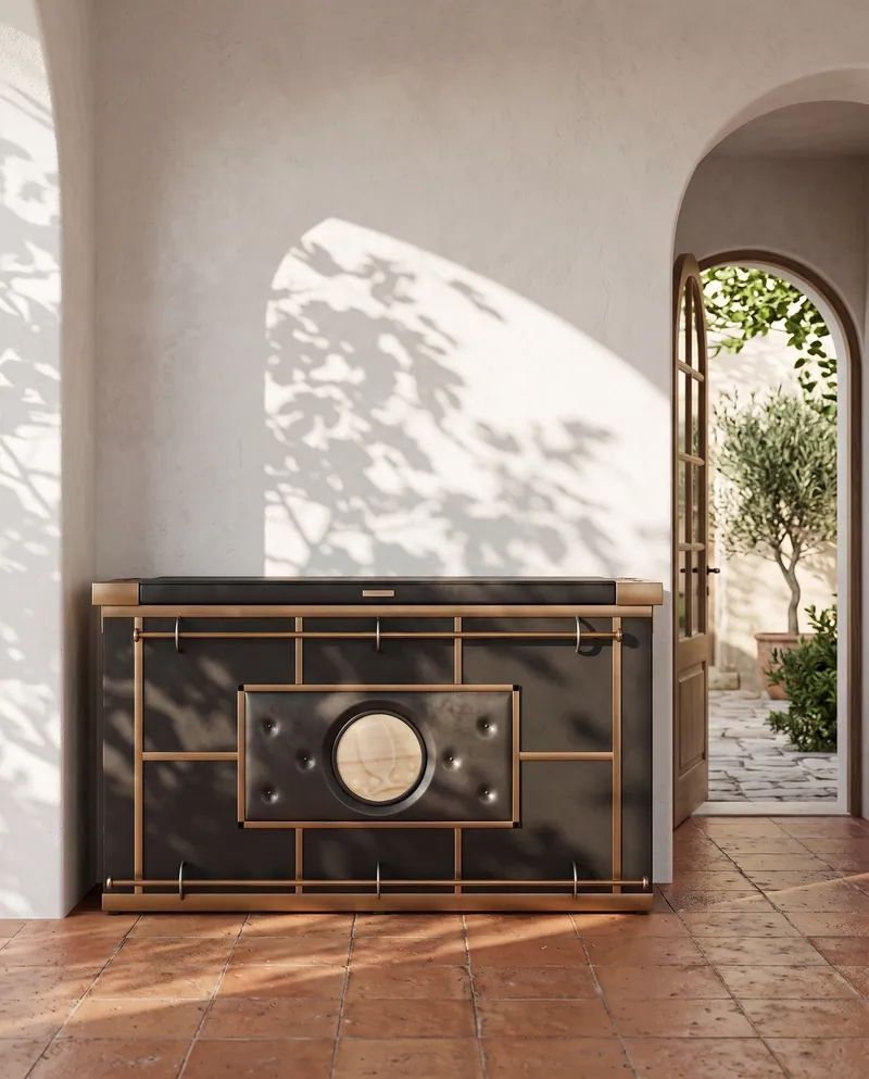The cabinet by an arched door, in leaf shadow